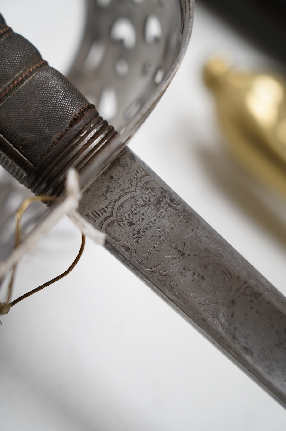 An 1895 pattern late Victorian infantry officer’s sword in its steel scabbard, made by E. Thurkle, 5 Denmark St. Soho, blade 83cm. Condition - good, however scabbard heavily cleaned